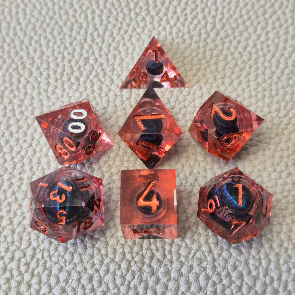 A set of red tinted clear liquid core dice with a moving dragon eye inside on a white textured background