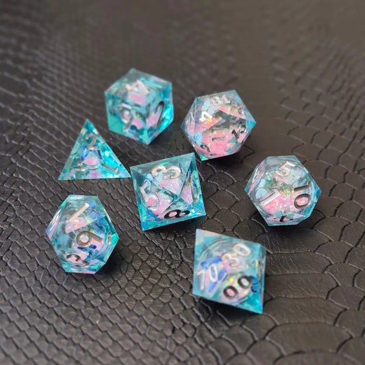 A set of light blue resin dice with pink liquid core and blue butterflies, displayed on black textured background