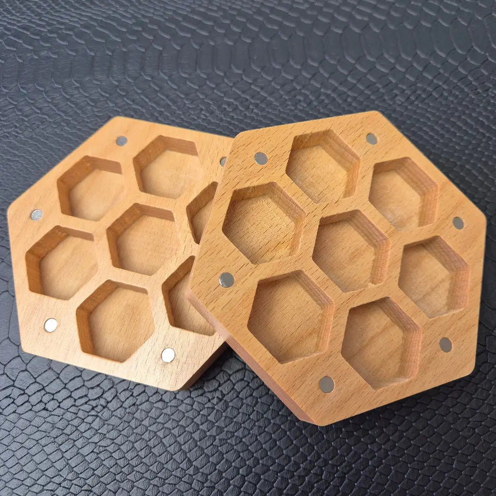 A Wooden Hexagon shaped dice storage box with magnets on a black textured surface