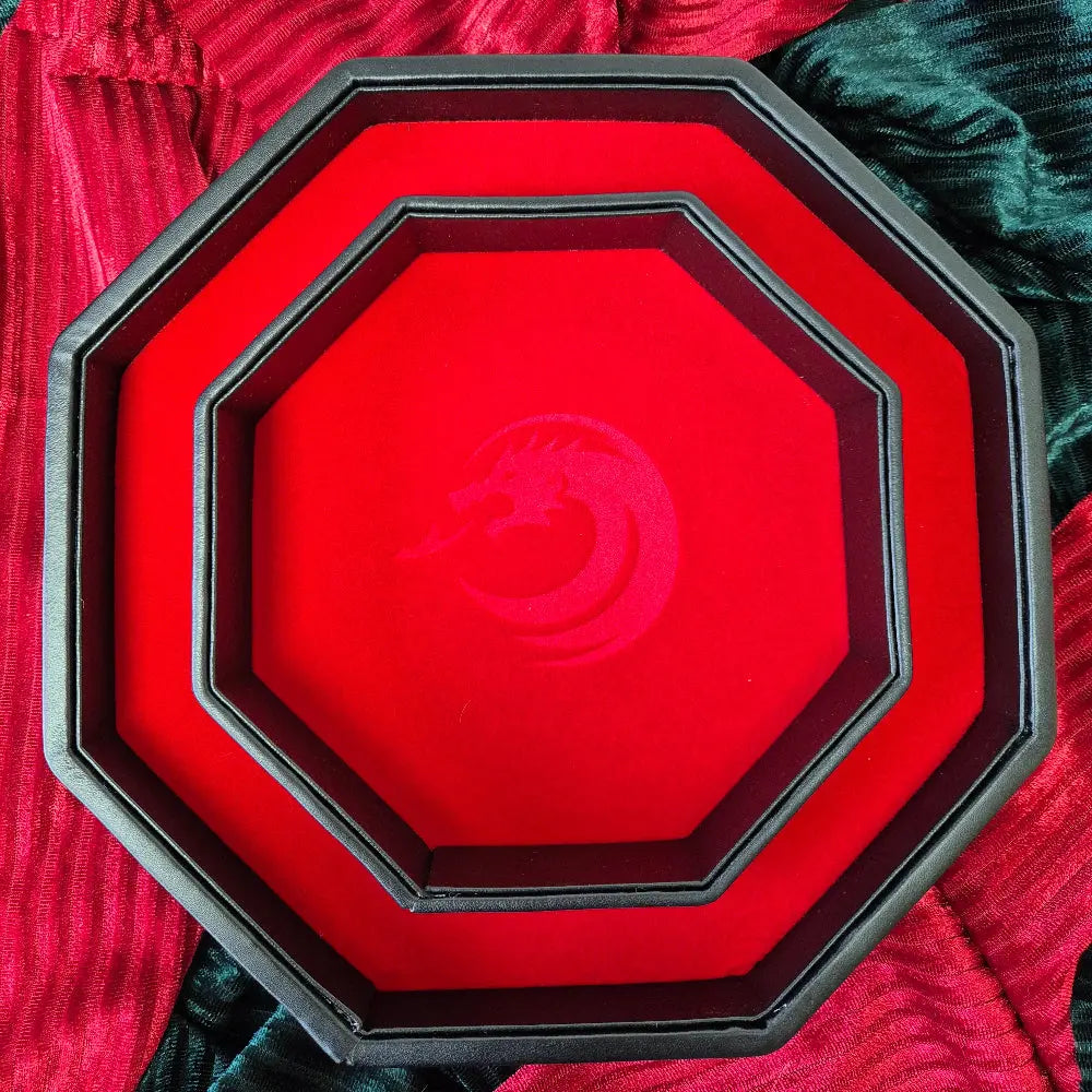 Octagonal red dice tray with dragon emblem and black leather edge, shown open.