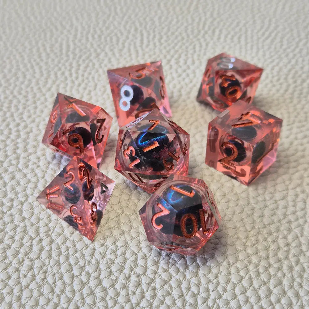 A set of red tinted clear liquid core dice with a moving dragon eye inside on a white textured background