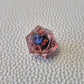 A set of red tinted clear liquid core dice with a moving dragon eye inside on a white textured background