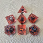 A set of red tinted clear liquid core dice with a moving dragon eye inside on a white textured background