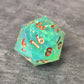 Sharp-edge D20 dice set with clear aqua blue resin, filled with holographic foil flakes and copper inked numbers, displayed on a black surface.