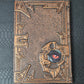 A bronze coloured notebook/journal for DND and other TTRPG games
