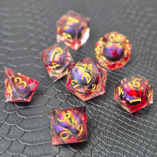 A set of clear red tinted liquid core resin dice with a moving dragon eye inside, displayed on a black textured surface