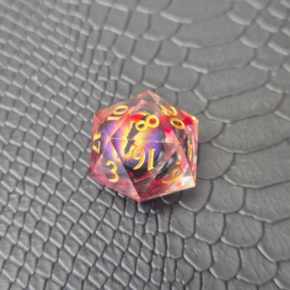 A set of clear red tinted liquid core resin dice with a moving dragon eye inside, displayed on a black textured surface