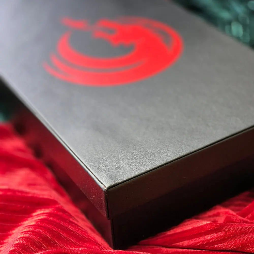 A black-and-red 3-in-1 dice tower, dice tray, and dice storage box with a dragon motif, perfect for tabletop gaming.