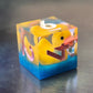 Whimsical sharp-edge D6 with floating yellow ducks and pink numbering, set in clear resin over a blue water-like base.