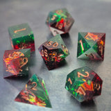 A set of Green and red sharp edge dice filled with sparkles and gold numbers.
