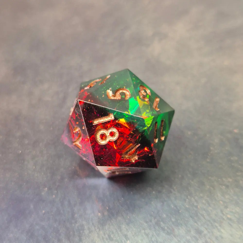 A set of Green and red sharp edge dice filled with sparkles and gold numbers.