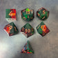 A set of Green and red sharp edge dice filled with sparkles and gold numbers.