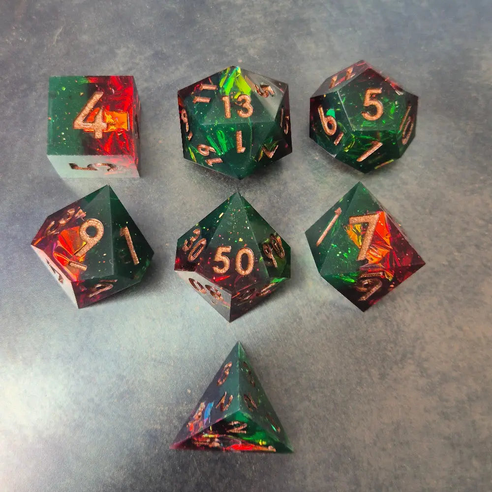 A set of Green and red sharp edge dice filled with sparkles and gold numbers.