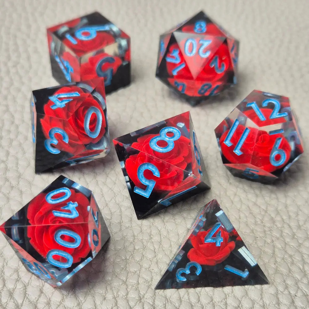 A set of clear sharp-edge resin dice with black ground color and red rose inside.