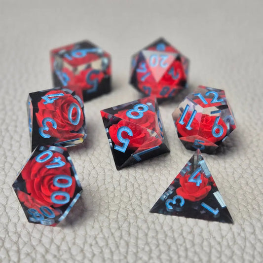 A set of clear sharp-edge resin dice with black ground color and red rose inside.