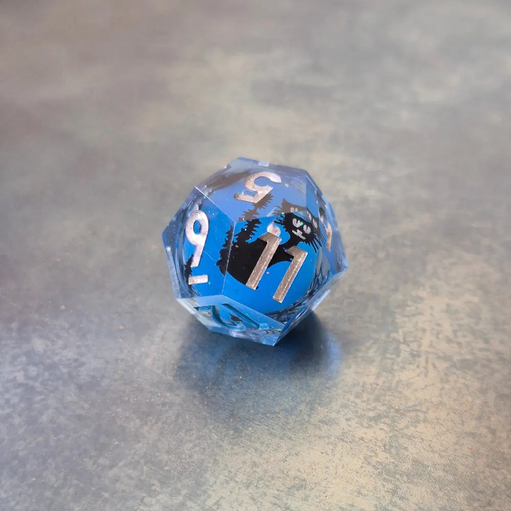 Blue sharp edge resin dice set with liquid core and black cat stickers on metal plate