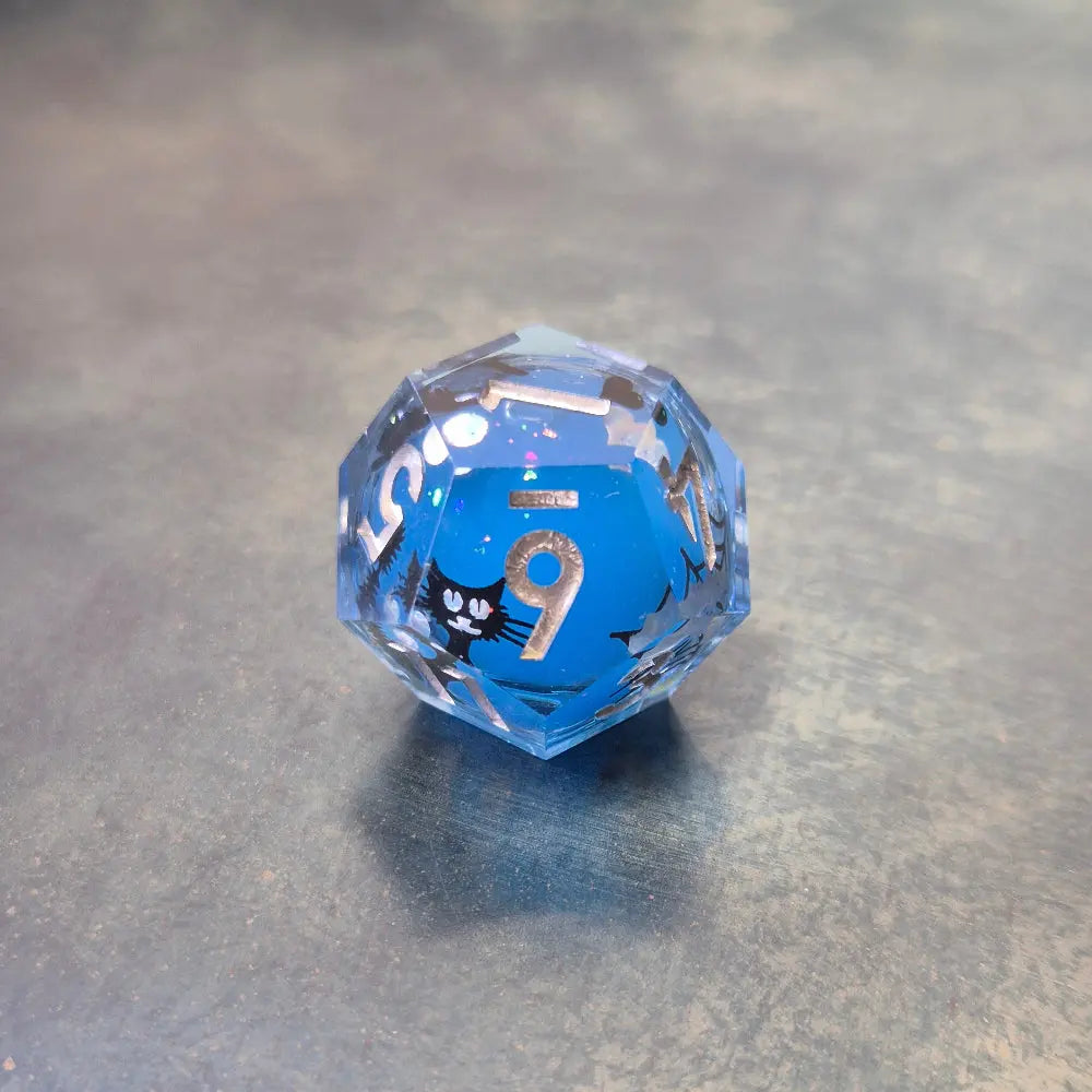 Blue sharp edge resin dice set with liquid core and black cat stickers on metal plate