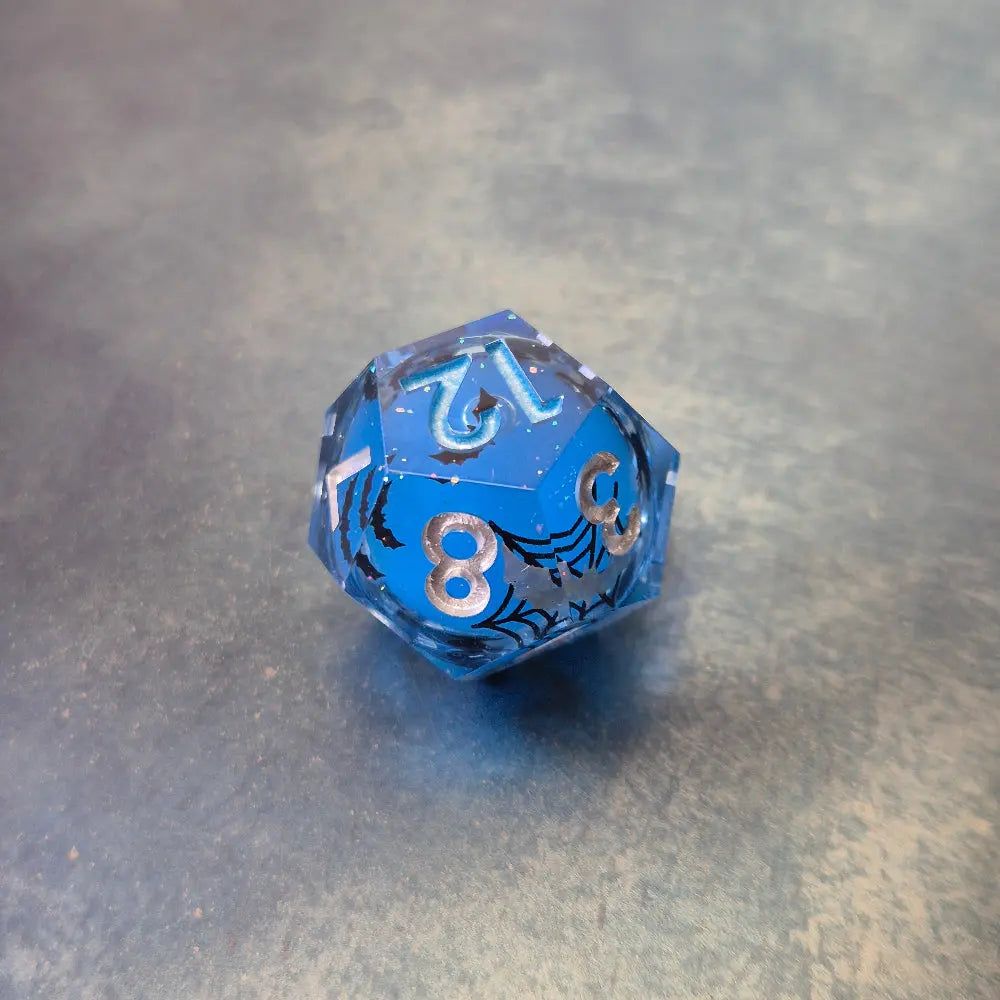Blue sharp edge resin dice set with liquid core and black cat stickers on metal plate
