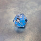 Blue sharp edge resin dice set with liquid core and black cat stickers on metal plate