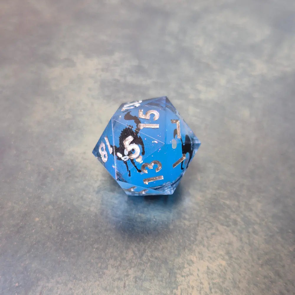 Blue sharp edge resin dice set with liquid core and black cat stickers on metal plate