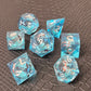 A set of clear light blue tinted liquid core dice with koi fish and glitters inside, displayed on a black textured surface
