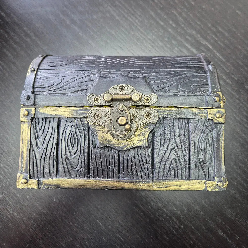 A brown ang gold mimic chest for dice storage With red and black painted mimic with teeth inside
