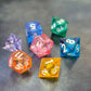 A set of rainbow coloured resin dice witch liquid core displayed on metal plate