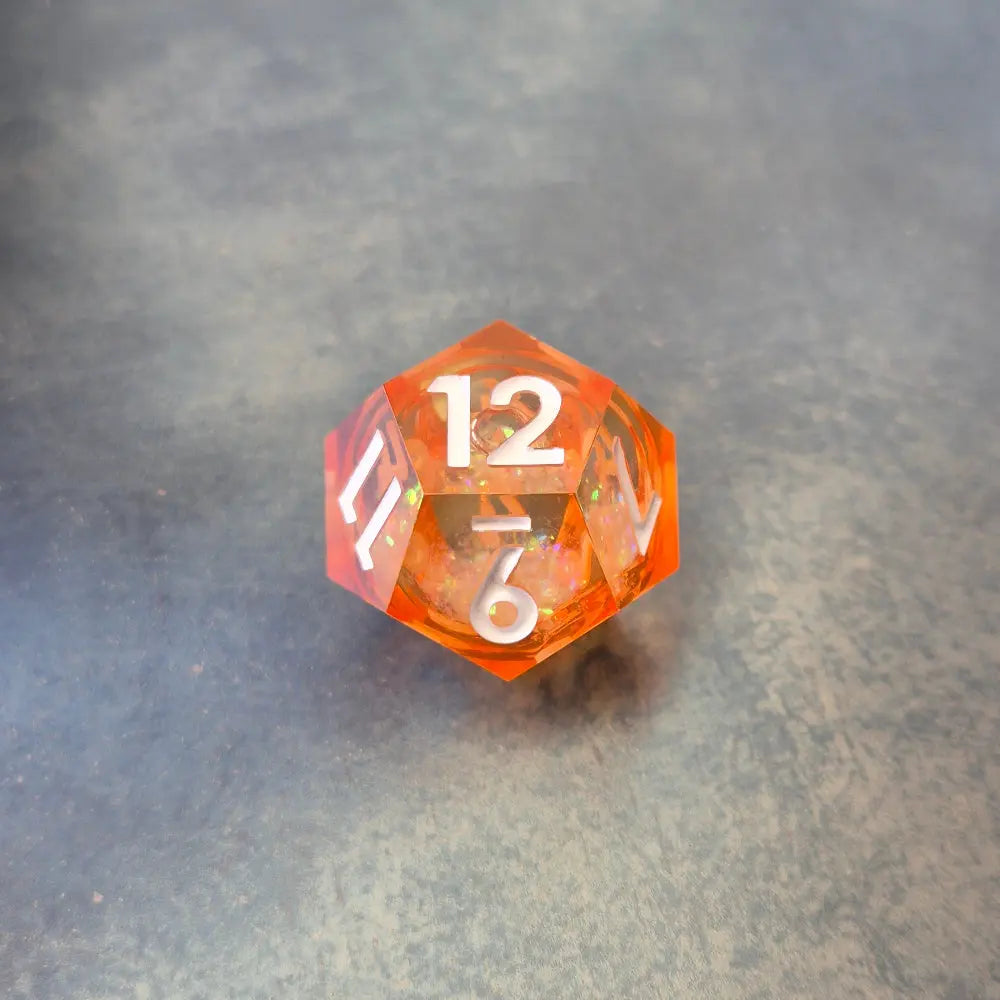 A set of rainbow coloured resin dice witch liquid core displayed on metal plate