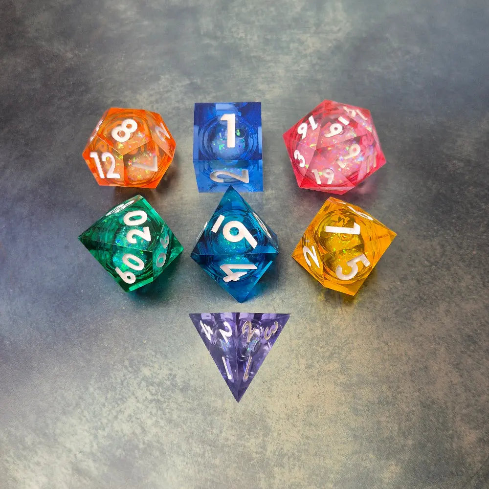 A set of rainbow coloured resin dice witch liquid core displayed on metal plate