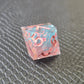 Sharp edge resin dice set. Pink and blue with sakura flowers and black textured blackground