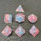 Sharp edge resin dice set. Pink and blue with sakura flowers and black textured blackground
