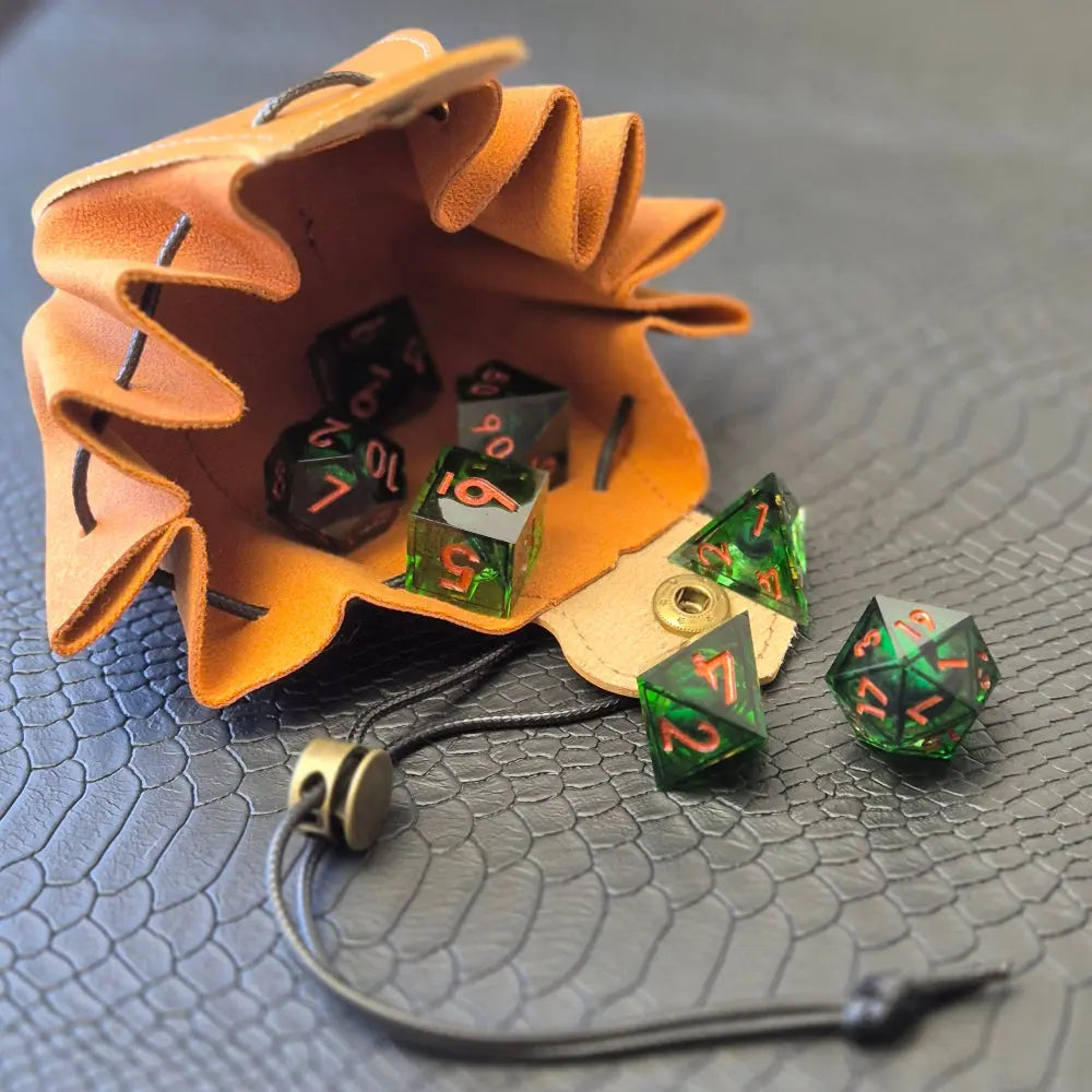 A brown leather dice bag with buttons and rope to tightly close it. Displayed on a black textured background