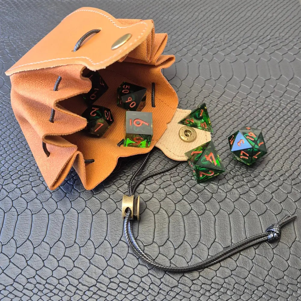 A brown leather dice bag with buttons and rope to tightly close it. Displayed on a black textured background