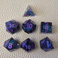 A set of purple sharp edge resin dice with blue confetti inside on a white textured surface