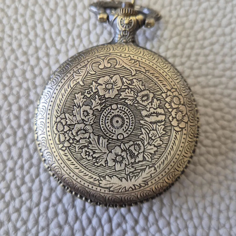 A Bronze coloured full metal pocket watch themed dice locket, with engraved backside and detailed kraken on the front. Contains full set of metal dice inside