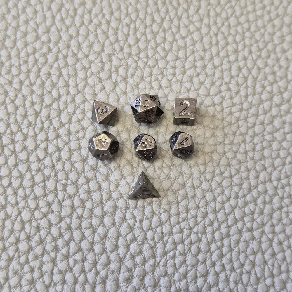 A silver coloured full metal pocket watch themed dice locket, with engraved backside and detailed kraken on the front. Contains full set of metal dice inside