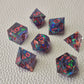 Set of colorful sharp edge dice on a textured surface