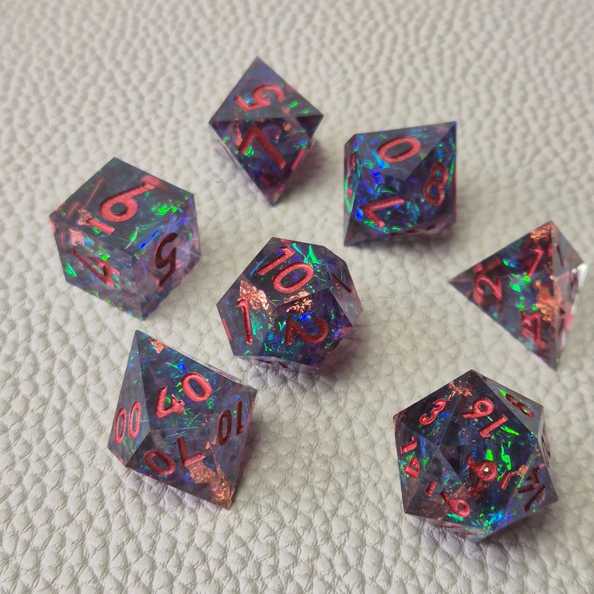 Set of colorful sharp edge dice on a textured surface