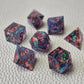 Set of colorful sharp edge dice on a textured surface