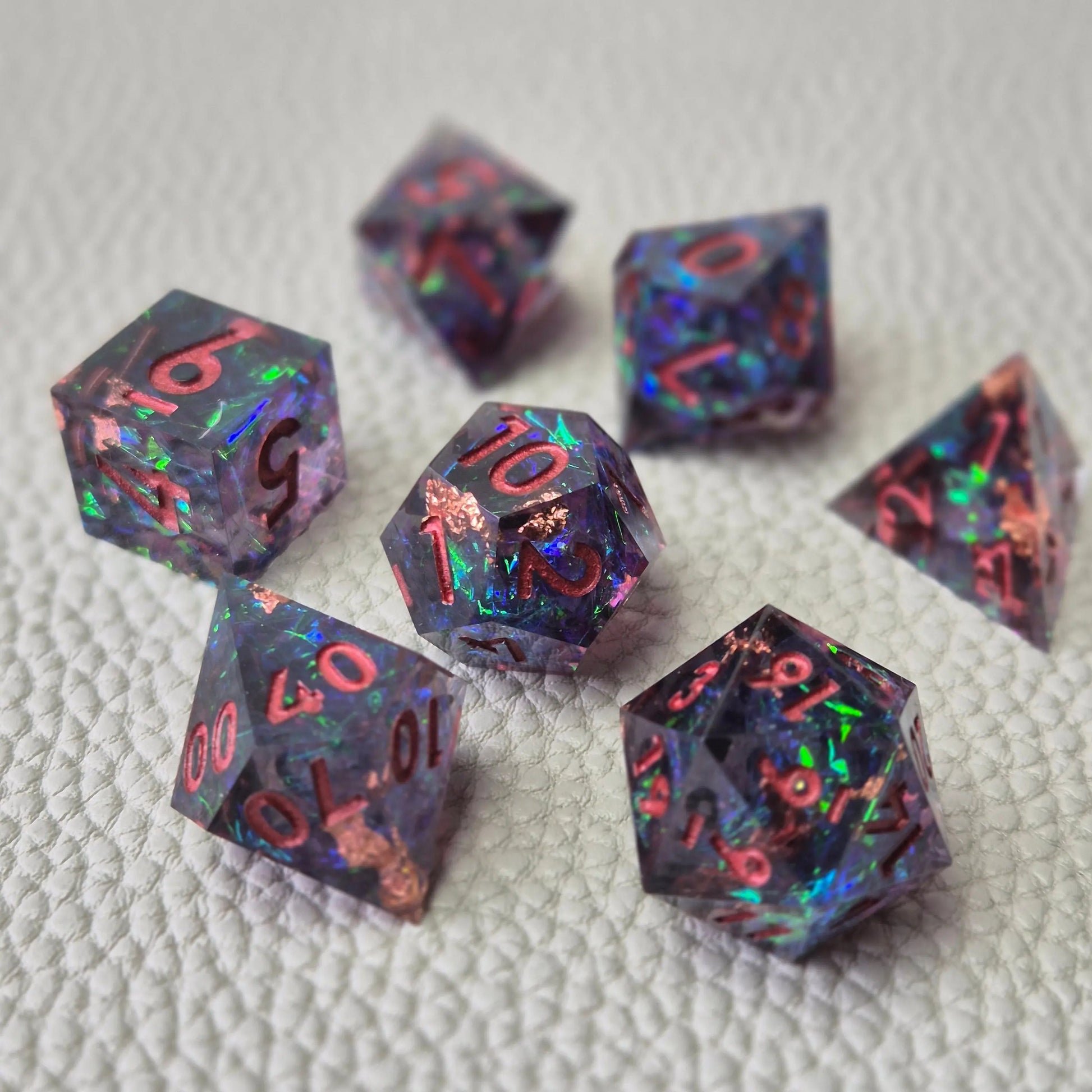 Set of colorful sharp edge dice on a textured surface