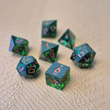 A set of clear green tinted liquid core dice with a moving eyeball inside