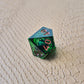 A set of clear green tinted liquid core dice with a moving eyeball inside