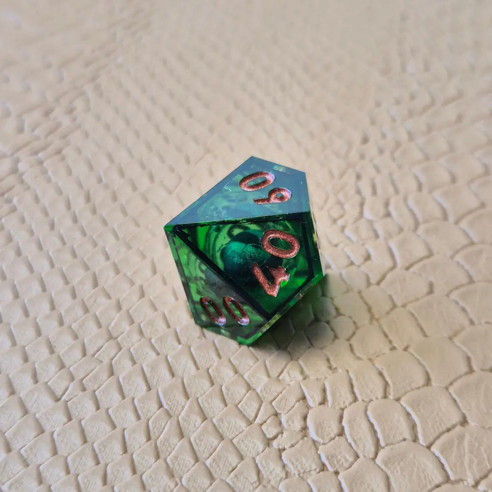 A set of clear green tinted liquid core dice with a moving eyeball inside