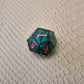 A set of clear green tinted liquid core dice with a moving eyeball inside
