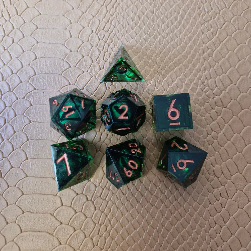 A set of clear green tinted liquid core dice with a moving eyeball inside
