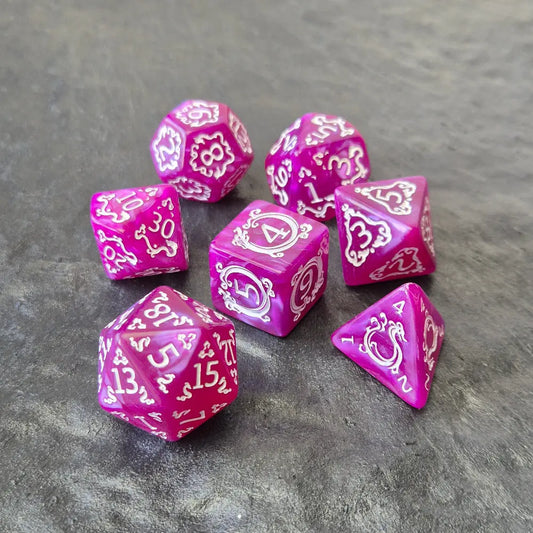 Purple acrylic polyhedral dice set with white ornate numbering, styled with arcane fantasy motifs, displayed on a stone surface.