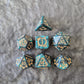 Acrylic D&D dice set with emerald green swirls and antique gold arcane-style numbering, displayed on a textured dark surface.