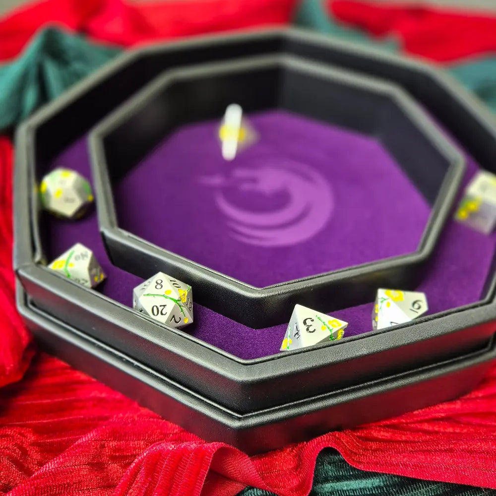 Purple double-layered octagonal dice tray with black borders and a violet dragon emblem in the center, displayed on a textured surface.