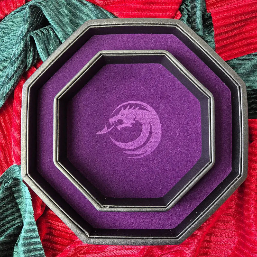 Purple double-layered octagonal dice tray with black borders and a violet dragon emblem in the center, displayed on a textured surface.