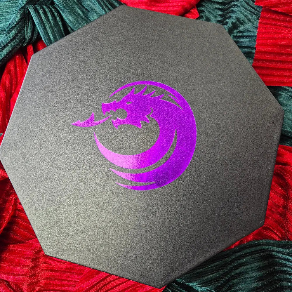 Purple double-layered octagonal dice tray with black borders and a violet dragon emblem in the center, displayed on a textured surface.